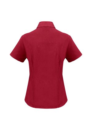 Back view of a red short-sleeve collared shirt with a rounded hem, worn on a mannequin or form.