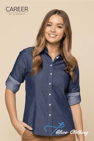 Smiling woman modeling a navy blue dotted button-down shirt with rolled cuffs for Career by GlowEave; Alice Clothing watermark in corner.