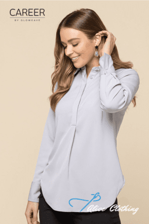 Model wearing a light blue, long-sleeve blouse with a hidden placket, posing in a studio.
