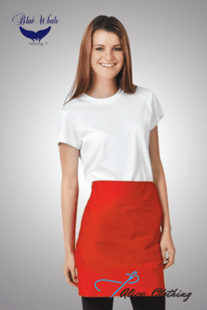 Smiling woman model wearing a white T-shirt tucked into a bright red knee-length skirt, standing with one hand at her side; branding logos at corners.
