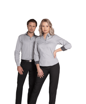 Two professionals standing side by side in gray shirts and black pants, posing for a corporate photo.