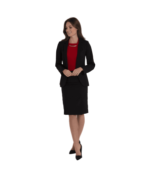 Professional woman standing in a black blazer and skirt with a red top, smiling with hands loosely clasped in front.