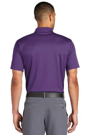 Back view of a man wearing a purple polo shirt tucked into gray trousers with a black belt.