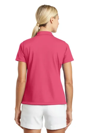 Back view of a woman wearing a pink short-sleeve polo shirt and white shorts, with blonde hair in a ponytail.