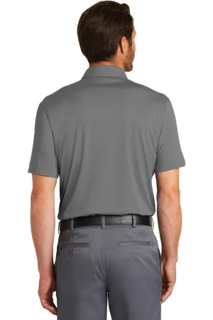 Back view of a man wearing a gray polo shirt tucked into gray dress pants with a black belt.