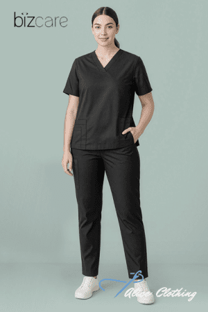 Woman wearing black medical scrubs (V-neck top with pockets and matching pants) standing against a teal backdrop; Bizcare logo in the top-left and Alive Clothing watermark bottom-right.