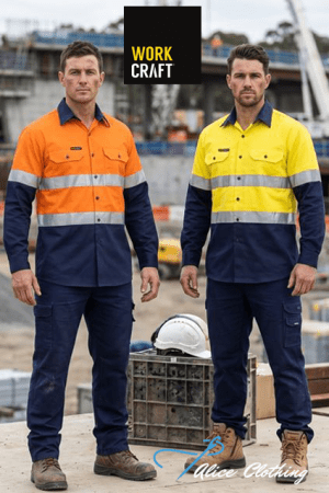 Two men in bright hi-vis work shirts with reflective bands stand at a construction site, one in orange and the other in yellow, with a helmet and crate nearby.