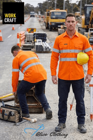 Two construction workers in bright orange safety vests on a road work site; one holds a yellow helmet. WorkCraft logo in the top-left.