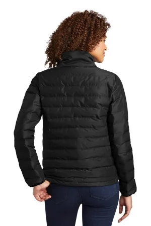 Back view of a person wearing a black quilted puffer jacket and dark jeans.