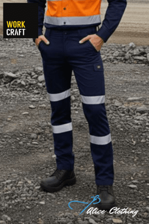 Person wearing navy high-visibility work pants with reflective bands on a construction site; orange safety vest and logo watermarks are visible.