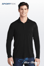 Smiling man in a black long-sleeve polo shirt standing against a light gradient background; SPORT-TEK logo top left.