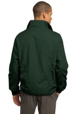 Back view of a person wearing a dark green windbreaker with a high collar and gray pants, seen from behind.