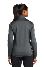 Back view of a woman wearing a dark gray athletic jacket with a ponytail