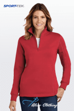 Product photo: smiling woman wearing a red quarter-zip fleece pullover, standing against a light gradient background; Sport-Tek logo in top-left.