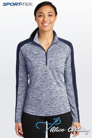 Woman wearing a blue-gray heathered athletic pullover with navy sleeves, standing against a light gradient background; SPORT-TEK logo visible in the upper left corner and 'Alice Clothing' script on her black leggings.