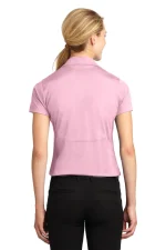Back view of a person with blonde hair in a low ponytail wearing a light pink polo shirt and black pants, against a white background.