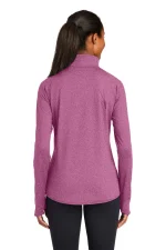 Woman viewed from behind wearing a long-sleeve pinkish-purple pullover with a high collar.