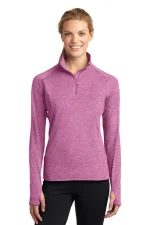 Woman modeling a pink heathered long-sleeve pullover with a short zipper and stand collar, against a white background.