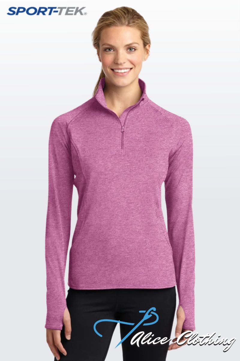 Model wearing a pink heathered quarter-zip athletic pullover; 'Sport-Tek' logo visible in the top left against a light gradient background.