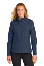 Woman wearing a navy blue quilted zip-up jacket with a stand collar.