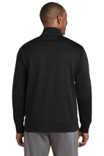 Back view of a man wearing a black jacket and gray pants, standing with arms at his sides