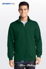 Male model wearing a dark green quarter-zip pullover on a white gradient background; Sport-Tek branding visible in the corner.