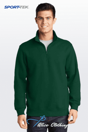 Male model wearing a dark green quarter-zip pullover on a white gradient background; Sport-Tek branding visible in the corner.