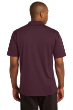 Back view of a man wearing a burgundy short-sleeve polo shirt, collar visible at the neck.