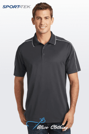 A man modeling a dark gray polo shirt with white piping, smiling, against a light gradient background (SPORT-TEC logo top left).